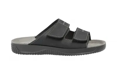 A black sandal on a white background.