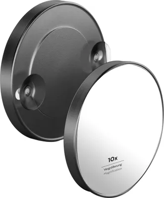 A black and silver magnifying mirror with suction cups attached to a wall mount.