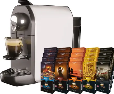 A coffee machine with a cup of coffee being dispensed, and a large display of coffee capsule boxes.