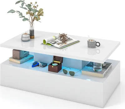 A modern, glossy white coffee table with LED lighting and various decorative items placed on and inside it.