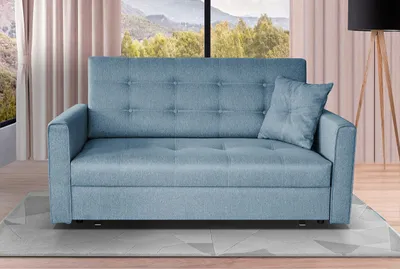A blue sofa bed is shown in a room with a large window and curtains in the background.