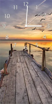 Produktbild von Wallario Design Wanduhr bedruckt, Größe 30 x 60 cm, Motiv: Sonnenuntergang über dem See  idyllischer Steg