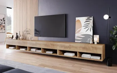 A modern living room with a TV stand and television.