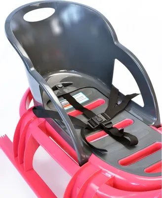 A close-up view of a pink and gray child's sled with a safety harness.