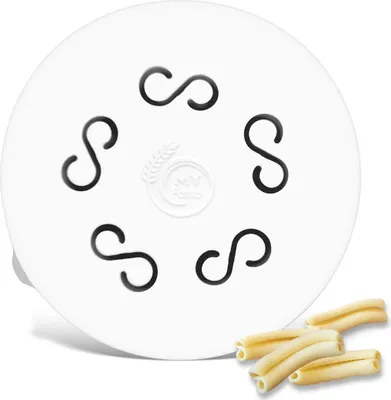 A white pasta maker disc with 'S' shaped holes and a logo in the center, with a few pieces of pasta in the foreground.