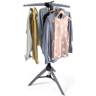 A drying rack with clothes hanging on it, shown against a white background.