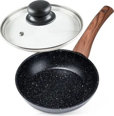 A frying pan with a glass lid is shown against a white background.