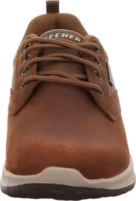 A close-up front view of a brown leather Skechers shoe.