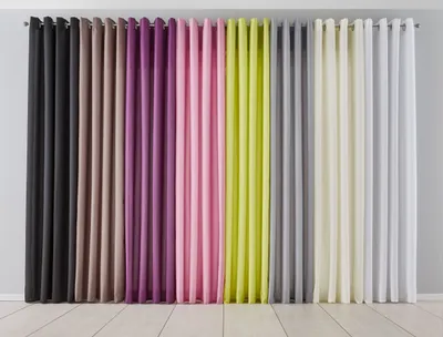 A row of colorful curtains hanging against a wall.