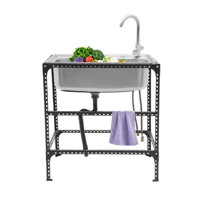 A stainless steel sink with a faucet and some vegetables on a black metal stand, with a purple towel hanging from the stand.