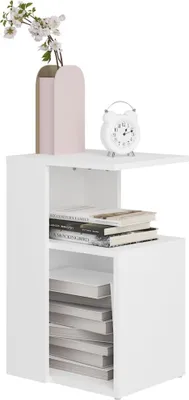 A white side table with books and a vase of flowers.
