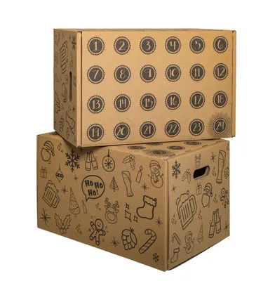 Two cardboard boxes stacked on a white background. The top box has numbered circles for an advent calendar. The bottom box is decorated with various Christmas and beer-related illustrations.