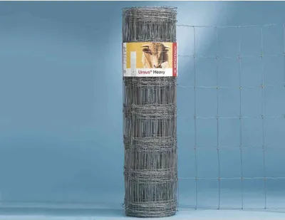 A roll of wire fencing is shown against a light blue background, with a section of unfurled fence visible to the right.