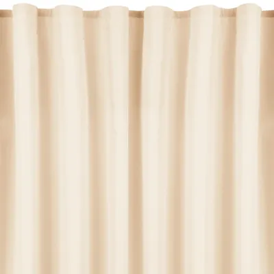 A close-up view of beige curtains with vertical pleats.