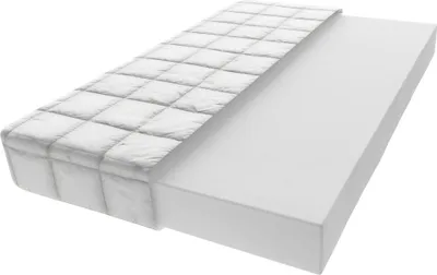 A mattress is shown on a white background, with one half covered by a quilted white fabric and the other half showing the white foam.