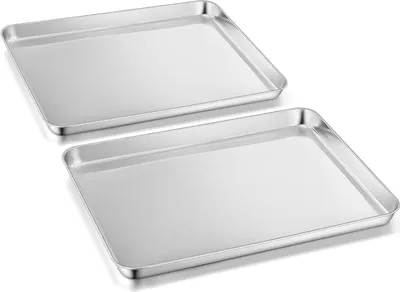 Two silver baking sheets are shown from a slightly elevated angle against a white background.