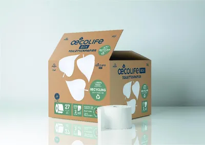 A cardboard box of toilet paper with one roll in front of it.