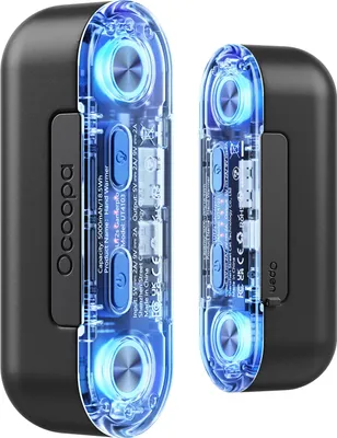 Two black Ocoopa hand warmers with transparent blue illuminated interiors are shown side-by-side against a black background.