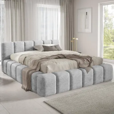 A modern bedroom with a large upholstered bed.