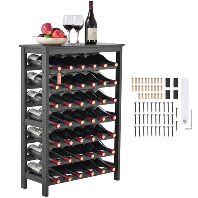 A black wine rack filled with wine bottles, with two wine glasses and a bowl of fruit on top.