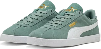 A pair of green Puma sneakers shown from a diagonal angle against a white background.
