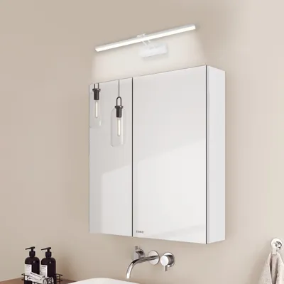 A modern bathroom vanity with a mirrored cabinet and wall-mounted light fixtures.