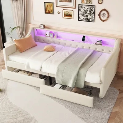A white daybed with tufted detailing, LED lighting, and storage drawers, styled with pillows and blankets.