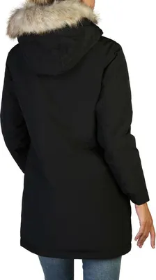 A woman wearing a black Calvin Klein parka.