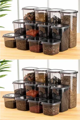 Two rows of clear plastic food storage containers filled with various dry goods, arranged on a wooden surface.