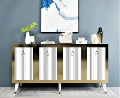 A modern sideboard with gold trim and white striped doors, displayed in a room with a blue wall and abstract art.