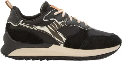 A side view of a black Diadora sneaker with a zebra-like pattern.