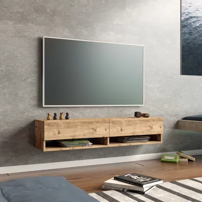 A modern living room with a wall-mounted TV stand and a large television.
