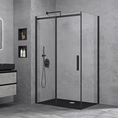 A modern bathroom with a black framed glass shower enclosure.