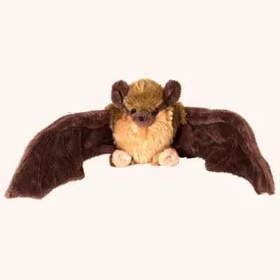A plush toy bat is shown lying down with its wings spread.