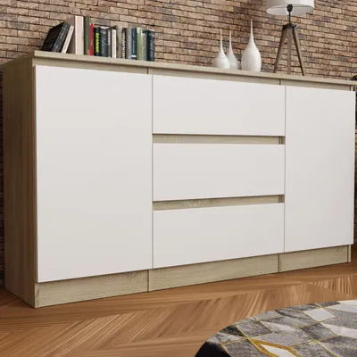 A modern sideboard with white drawers and wooden accents, placed against a brick wall.