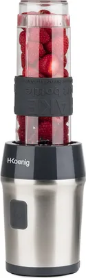 A mini smoothie maker with a clear container filled with red berries, placed on a white background.