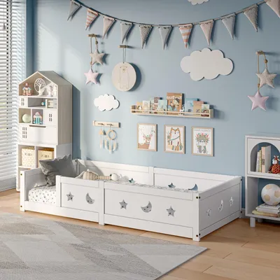 A child's bedroom with a white bed, decorated with stars and moons, and various wall decorations.