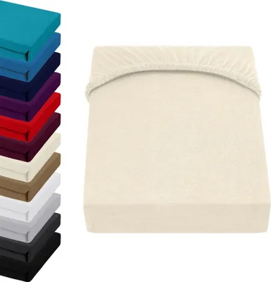 A stack of colorful fitted sheets is shown on the left, and a single cream-colored fitted sheet is displayed on the right.