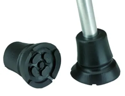 Two black rubber tips for a walking cane, one detached and showing its base, the other attached to the bottom of a cane.