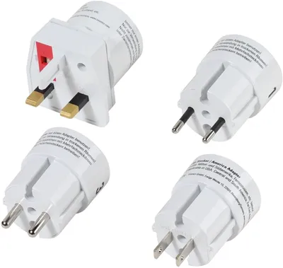 A set of four universal travel adapters arranged diagonally on a white background.