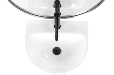A top-down view of a white sink with a black faucet.