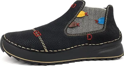 A side view of a black Chelsea boot with decorative stitching and colorful fish appliques.