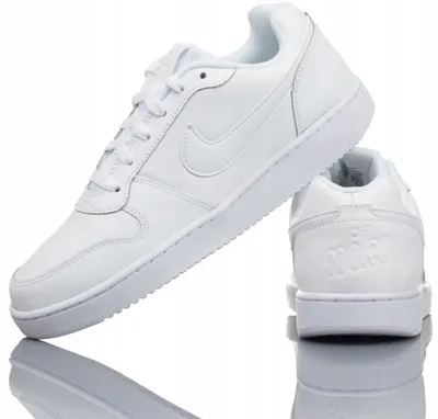 Product shot of white Nike sneakers on a white background.