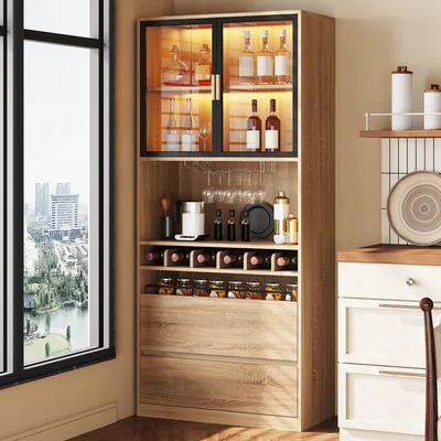 A tall, narrow cabinet with glass doors and LED lighting, filled with bottles and jars, is shown next to a large window overlooking a city.