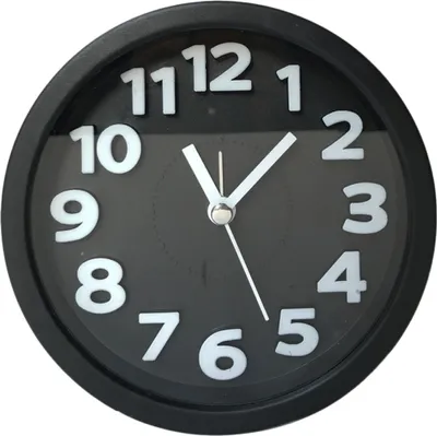 A close-up, front-facing view of a black analog alarm clock with white numbers and hands, set against a plain white background.
