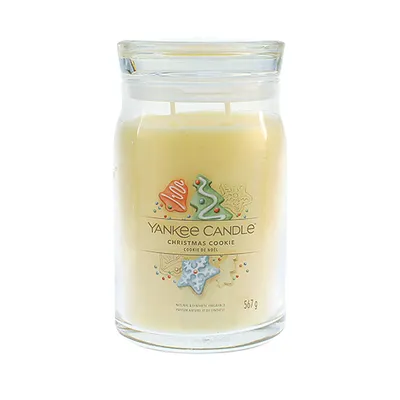 A Yankee Candle Christmas Cookie scented candle in a glass jar with a lid.