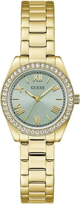 A close-up, studio shot of a gold-colored Guess watch with a light green face and crystal accents around the bezel.