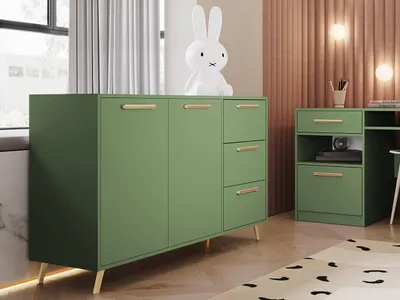 A green dresser with gold handles in a room with a window and a desk.