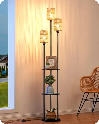 A floor lamp with shelves is placed next to a window and a chair in a room.