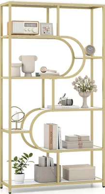 A gold and white geometric bookshelf filled with decorative items.